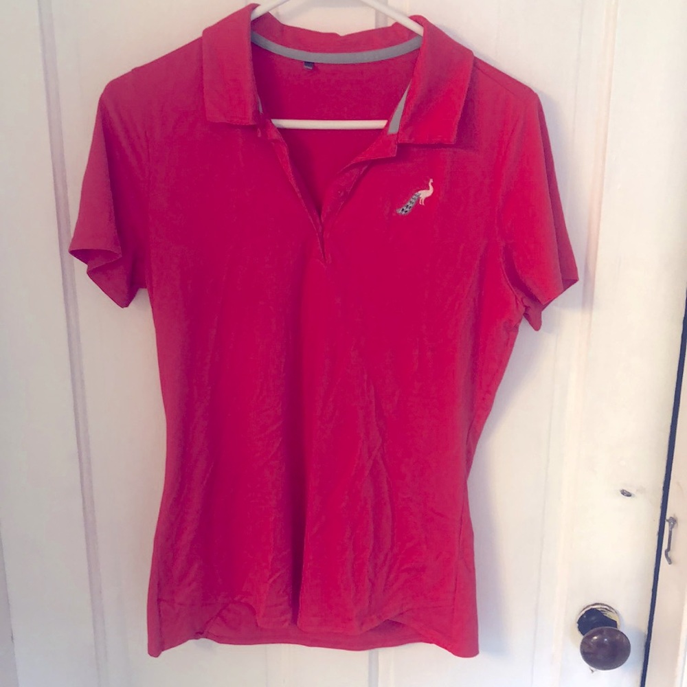 Under Armour hot pink golf polo with stitched silver peacock on left chest.
